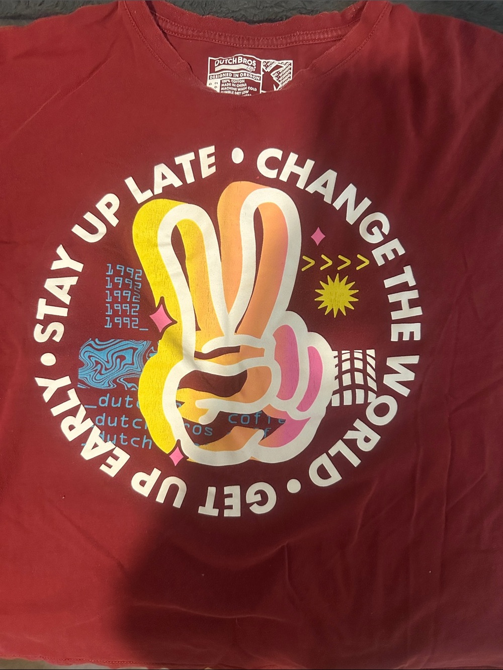 Dutch Bros Maroon Tee with Multicolor Peace Hand Graphic